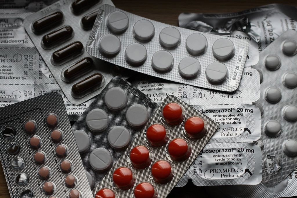 A selection of opened medication packets lie on a table.
